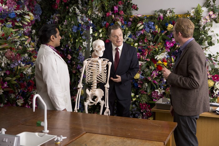 Simon Pegg with a skeleton and two men