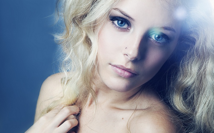 Blonde woman with blue eyes and light flare