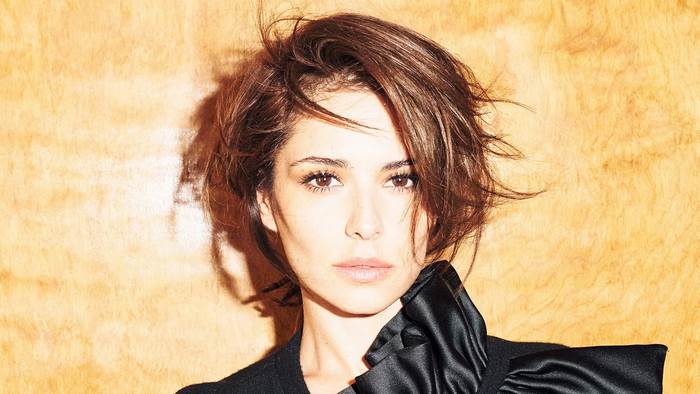 Woman with short brown hair and black jacket