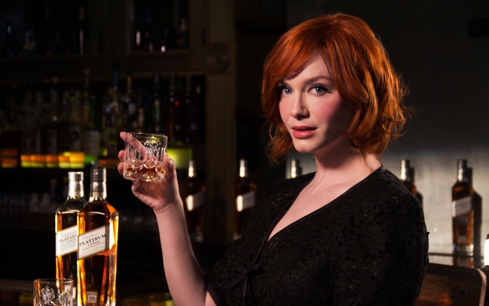 Christina Hendricks holding a whiskey glass