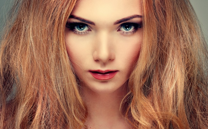 Close-up of a woman with blonde hair and blue eyes