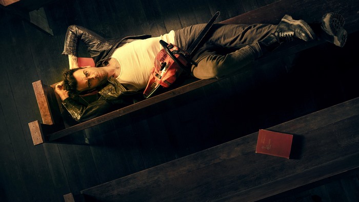 Joseph Gilgun with Chainsaw and Book