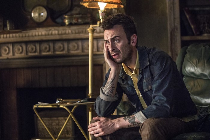 Joseph Gilgun sitting in a room