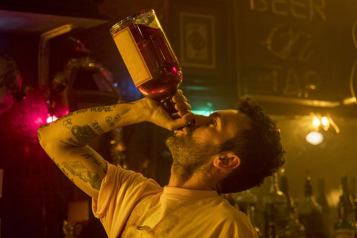 Joseph Gilgun drinking from a bottle