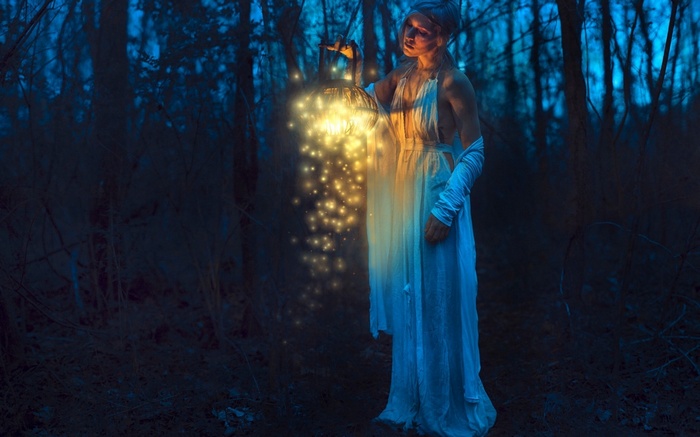 Woman holding a lantern in a dark forest