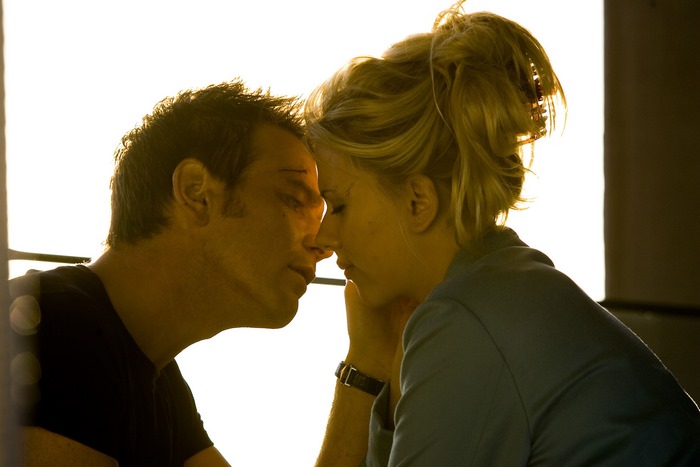 Ewan McGregor and woman in close embrace