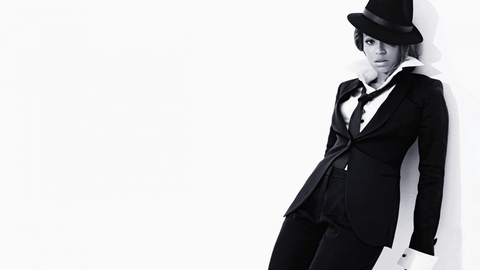 Beyoncé Knowles in a black suit and hat