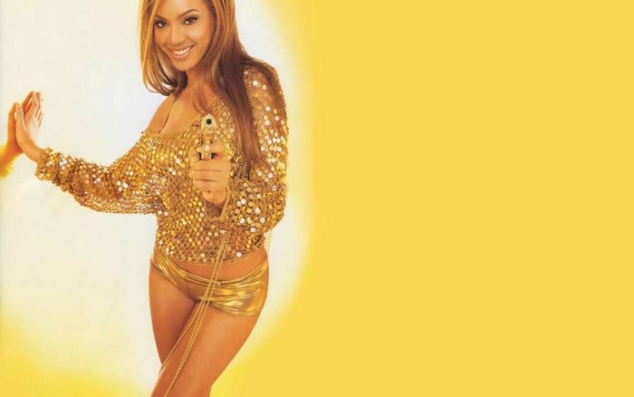 Beyoncé Knowles holding a golden gun