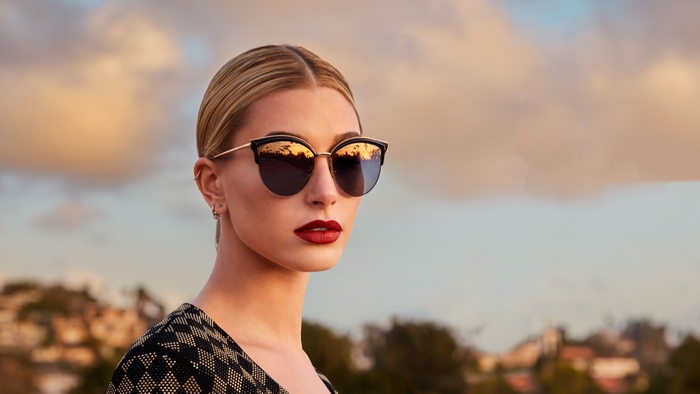 Hailey Baldwin wearing sunglasses at sunset