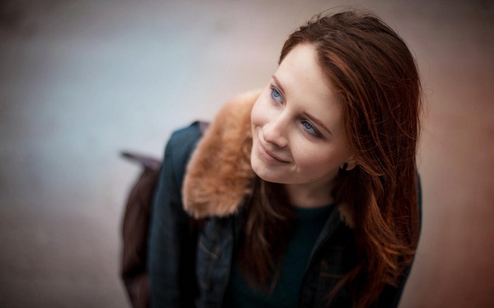 Woman with auburn hair and blue eyes