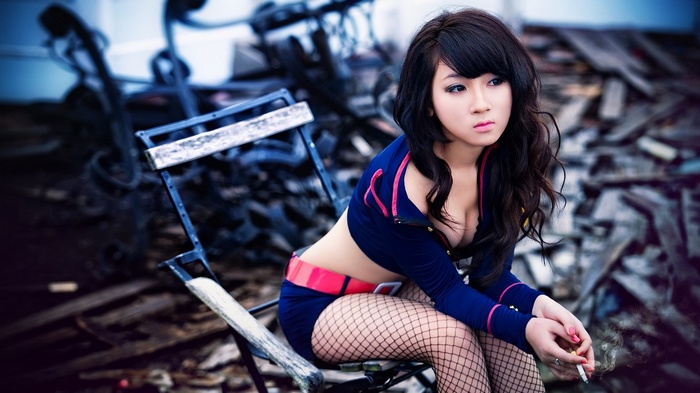Woman in blue outfit sitting on a chair