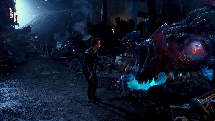 Charlie Day and a monster in a destroyed city