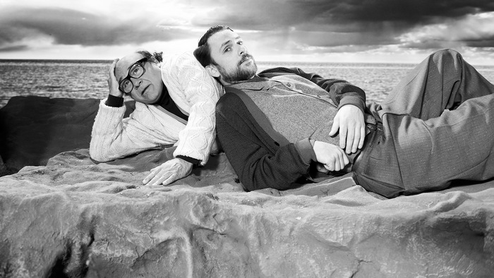 Charlie Day and Danny DeVito on a rocky shore