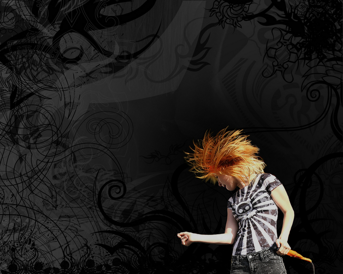 Hayley Williams performing with orange hair