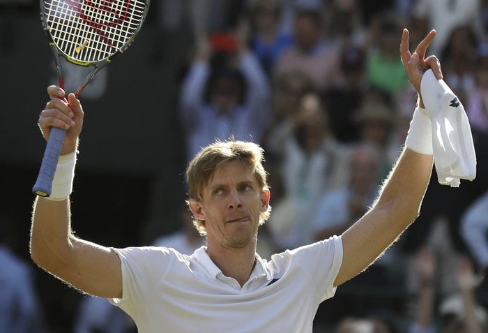 Kevin Anderson holding tennis racket and towel