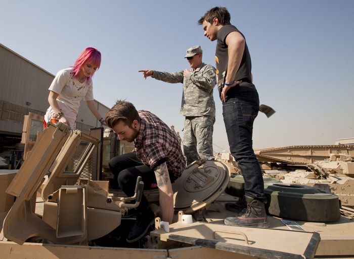 Hayley Williams with soldiers near a tank