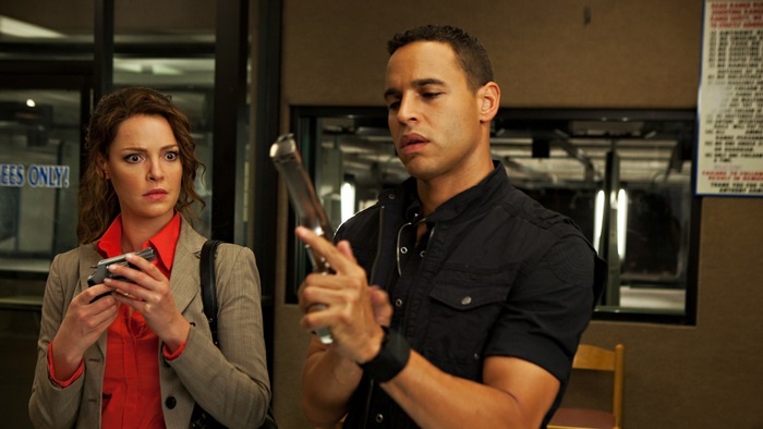 Katherine Heigl holding a gun