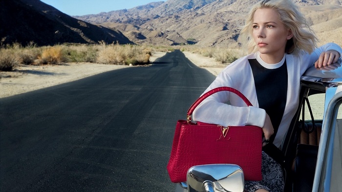 Michelle Williams with Louis Vuitton bag in desert
