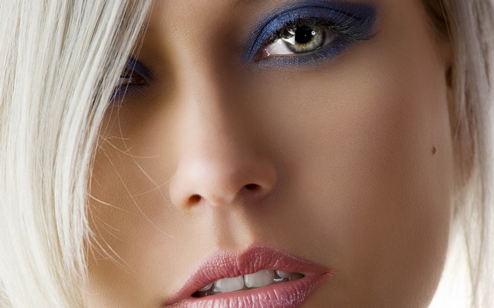 Close-up of a woman's face with blue eyeshadow