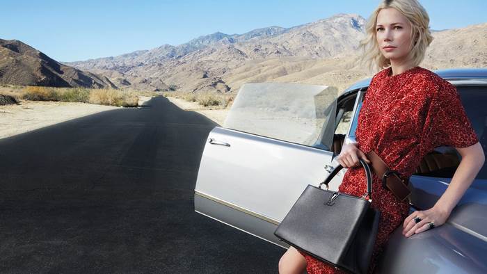 Michelle Williams with Louis Vuitton bag in desert