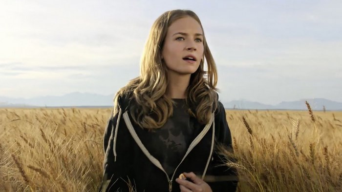 Britt Robertson in a wheat field