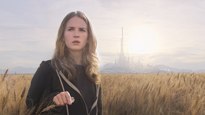Britt Robertson in a wheat field with a futuristic city