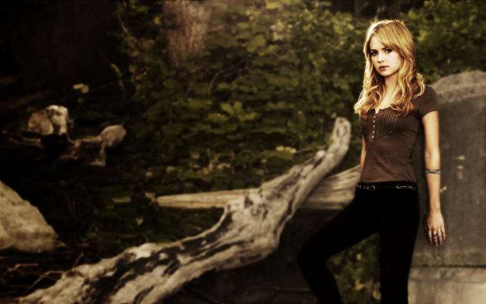 Britt Robertson in a forest
