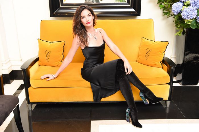 Lily Aldridge on a yellow couch
