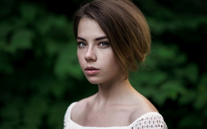 Young woman with freckles and brown hair