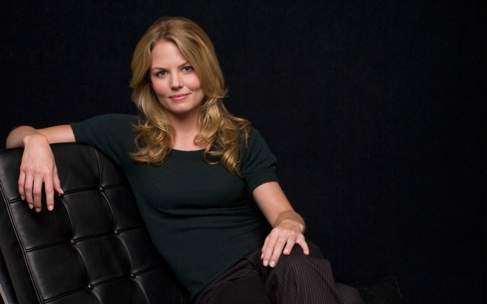 Jennifer Morrison sitting on a black couch