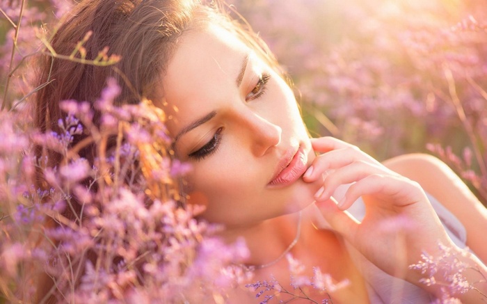 Woman lying in a field of purple flowers
