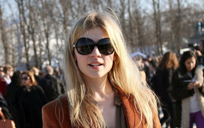 Clémence Poésy wearing sunglasses and a brown jacket