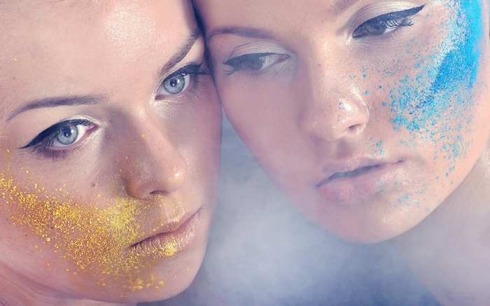 Two women with glitter makeup
