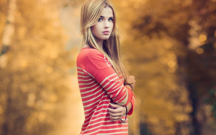 Young woman with blonde hair wearing a striped shirt