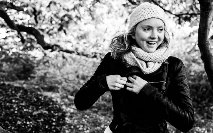 Lily Cole in a black jacket and scarf