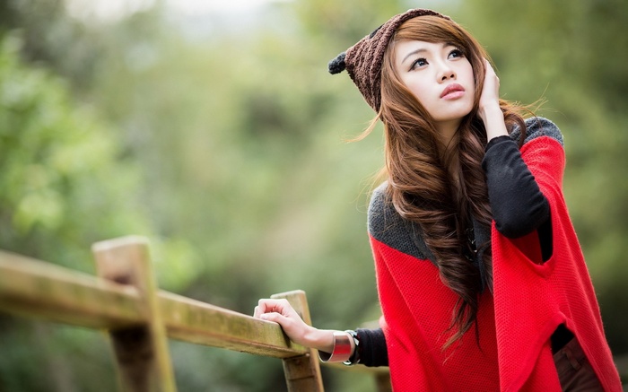 Young woman wearing a beanie and red poncho