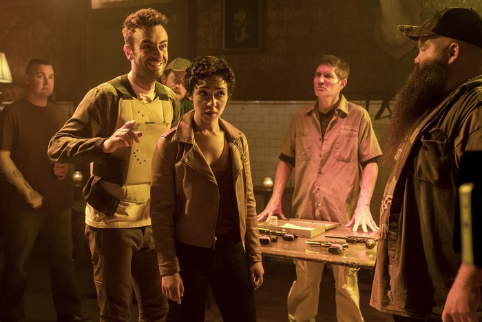Ruth Negga and men with guns