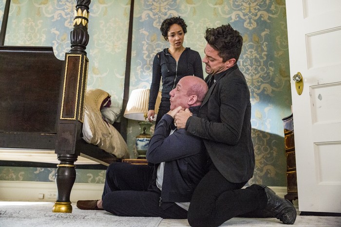 Ruth Negga and two men in a bedroom