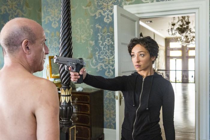 Ruth Negga holding a gun