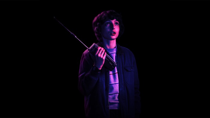 Finn Wolfhard holding a walkie-talkie