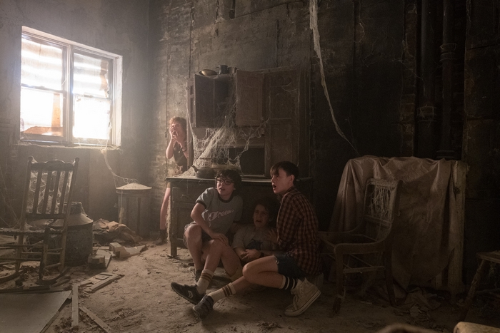 Children in a dusty, abandoned room