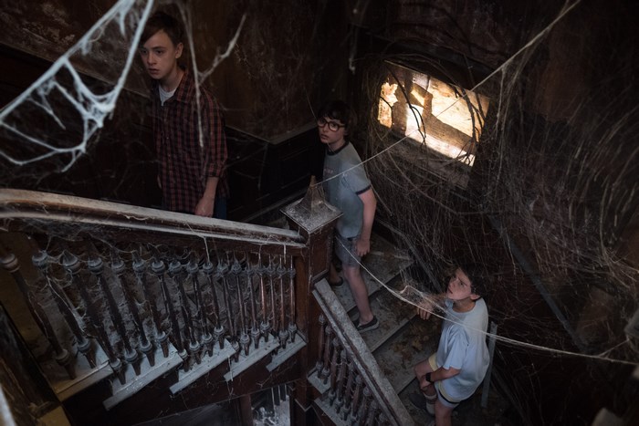 Children in a cobweb-filled house