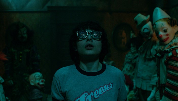 Finn Wolfhard in a room with creepy dolls
