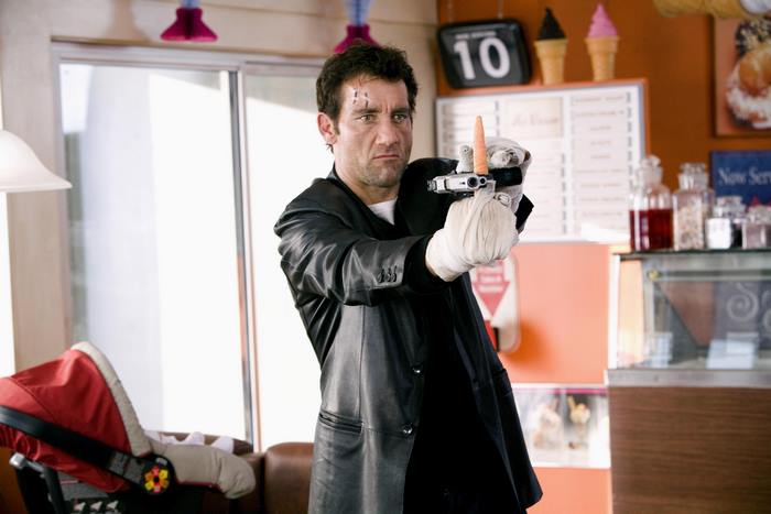Clive Owen holding a gun with a carrot