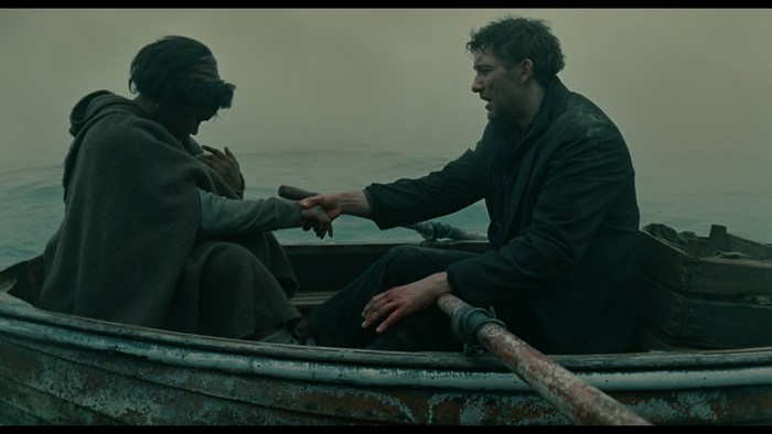 Clive Owen in a rowboat