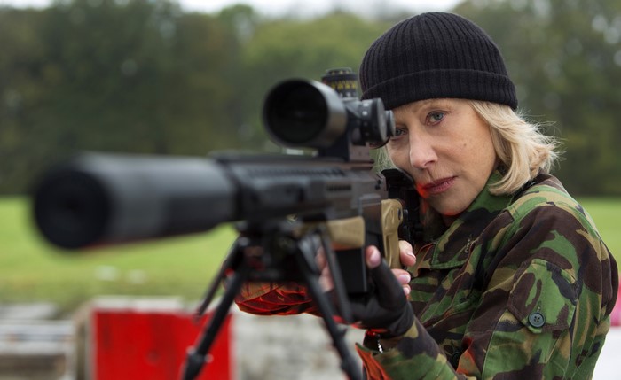 Helen Mirren aiming a sniper rifle