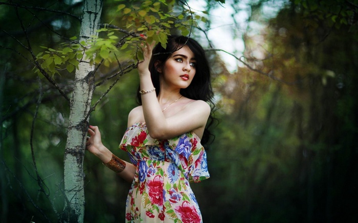 Woman in floral dress in a forest