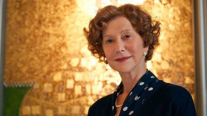 Helen Mirren in front of a gold painting