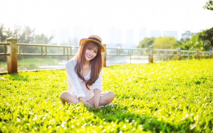 Young woman sitting on grass in a park
