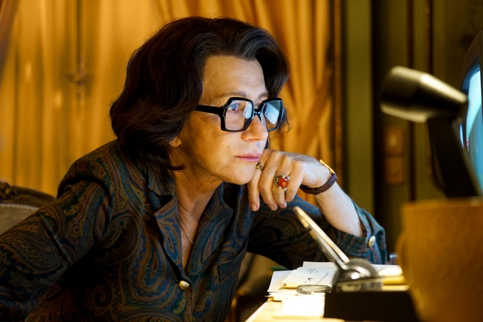 Helen Mirren wearing glasses and a patterned shirt